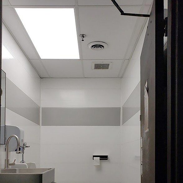 Trusscore wall&ceilingboard white and gray installed in bathroom facility