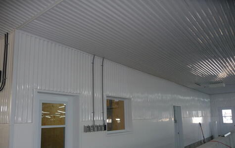 Trusscore white ribcore installed on the walls and ceiling of dairy facility