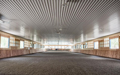 Trusscore white ribcore installed on the ceiling for a horse center riding arena