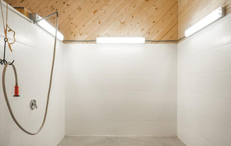 Trusscore white wallandceilingboard installed on the horse wash bay walls