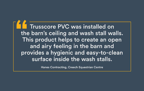 Trusscore white wallandceilingboard installed on the ceiling for a horse stable