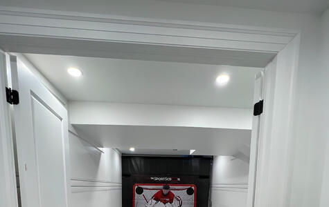 Trusscore white wallandceilingboard and slatwall installed in basement rec room