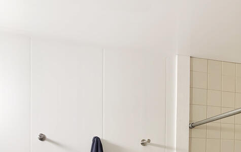 Trusscore white wall&ceilingboard installed vertically on bathroom walls with tile