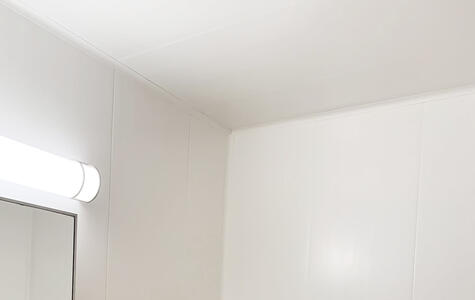 Trusscore white wall&ceilingboard installed vertically on bathroom walls with tile