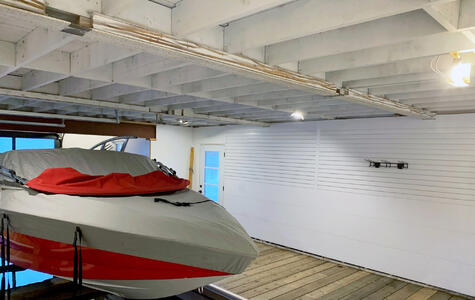 Trusscore white wall&ceilingboard and slatwall installed on the walls of a boathouse