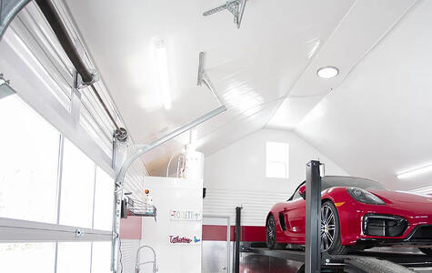Trusscore white wallandceilingboard and slatwall installed in a garage with hoist