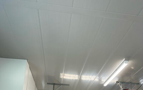 Trusscore white wall&ceilingboard installed on the walls and ceiling of a garage workshop