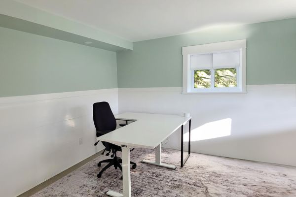 Finished room with white Trusscore Wall&CeilingBoard on the lower walls and a desk and chair by the window